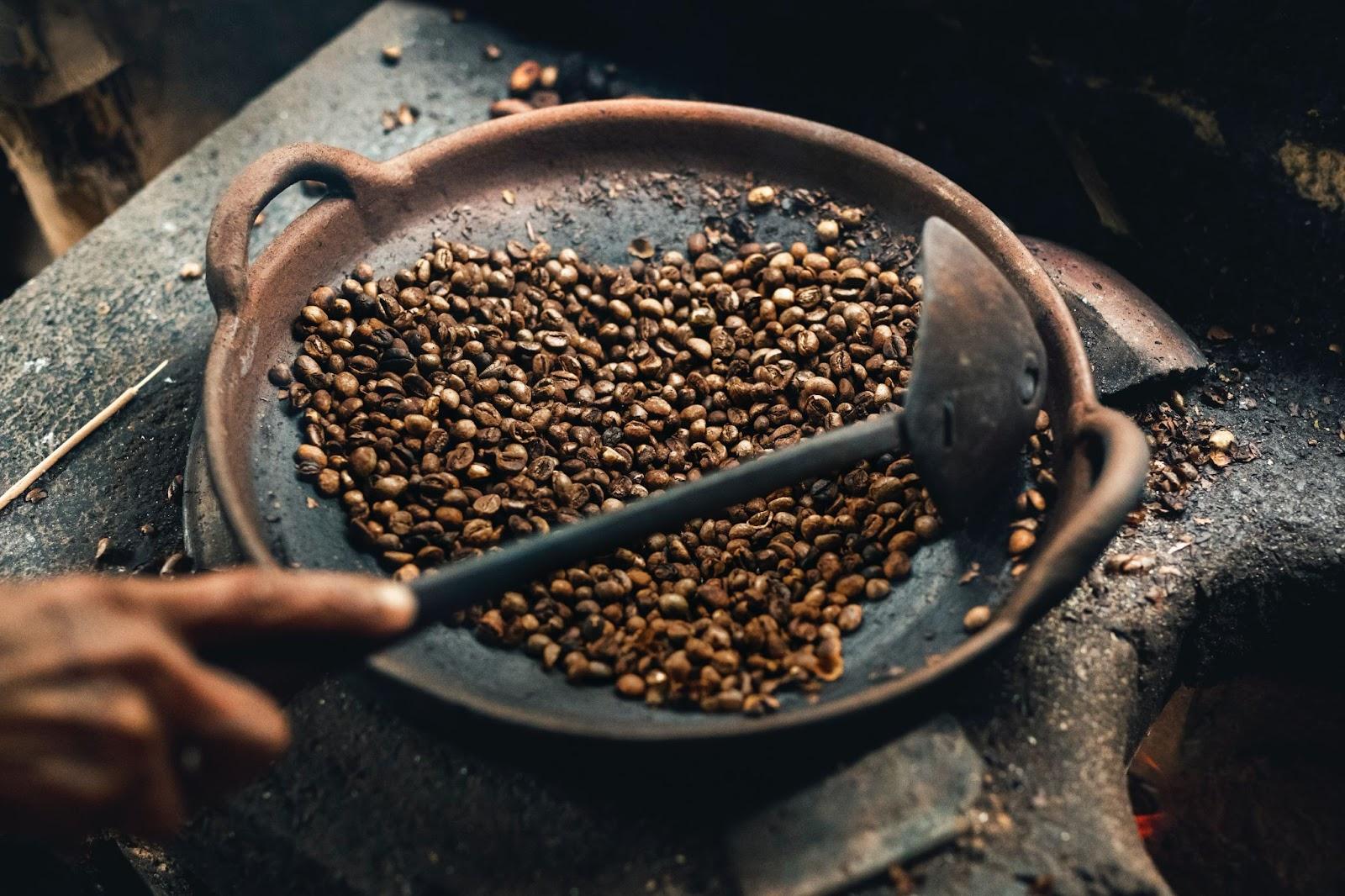 Coffee beans roasting on a flat pan