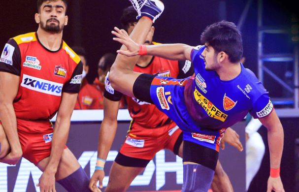 Naveen Kumar in action as he attempts to kick Bharat for a touchpoint against the Bulls
