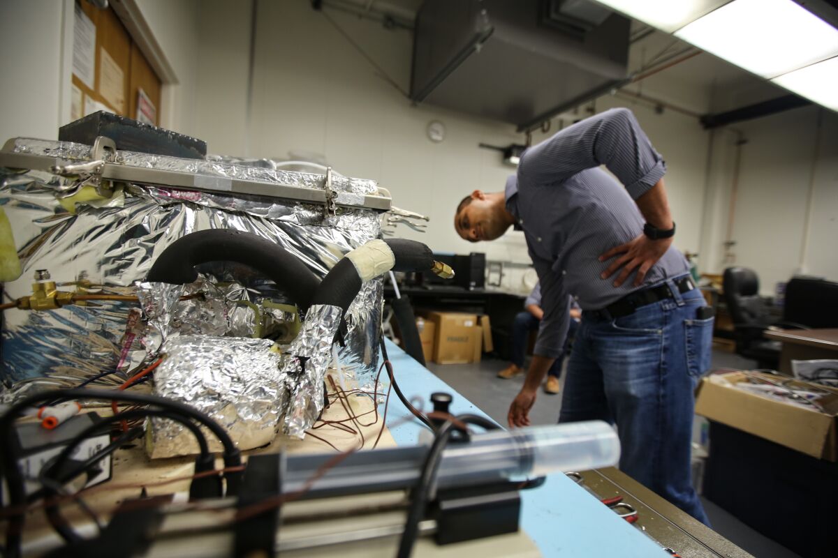 Gaurav Sant inspects the brick-curing machine 