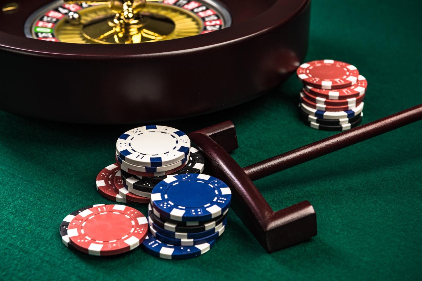 A close-up of a roulette wheel and poker chips

Description automatically generated with low confidence