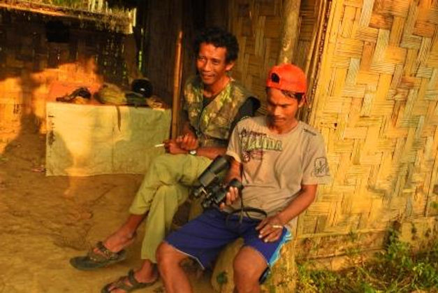 Heru (left) and local guide sitting on the shelter