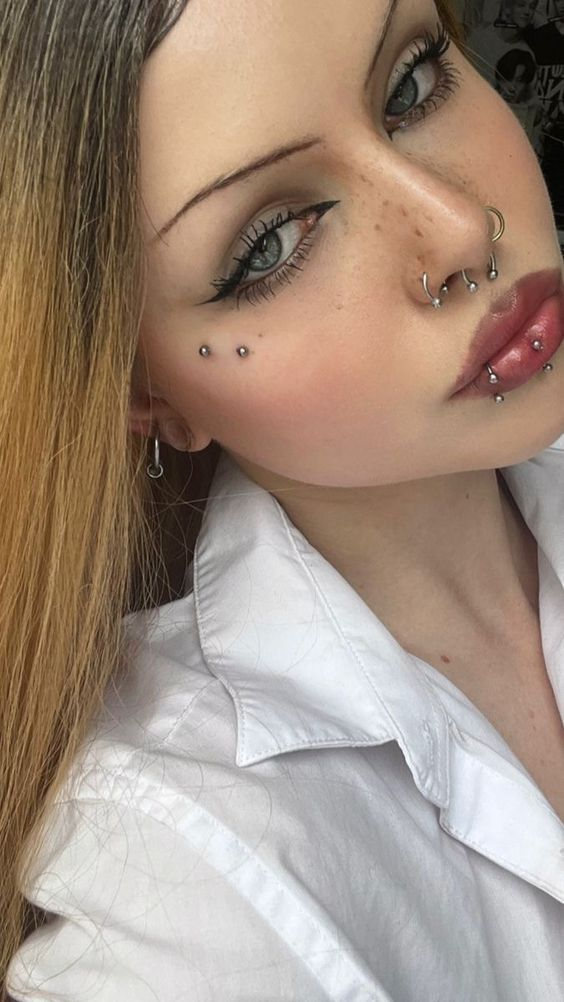Another picture showing a girl with her anti-eyebrow face piercing