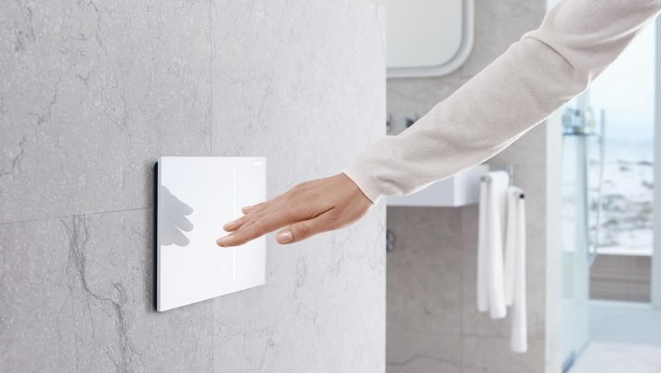 A wall-mounted touchless actuator plate for small bathroom design