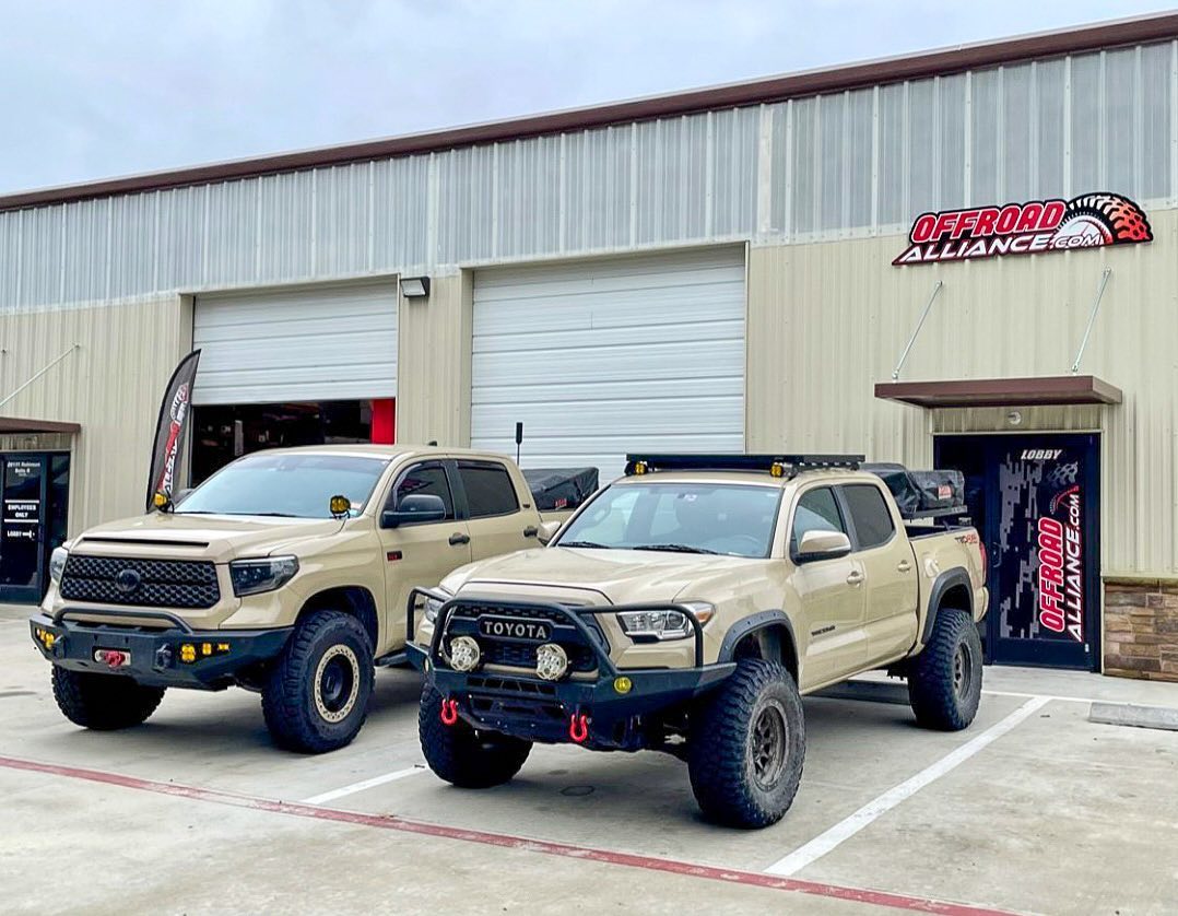 Toyota Tacoma & Toyota Tundra off-road ready trucks parked in front of Offroad Alliance shop
