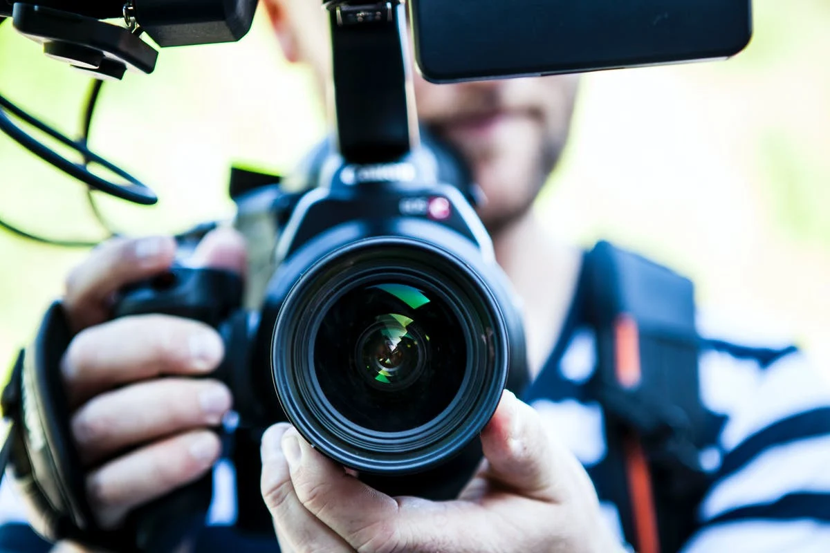 Man recording a video blog with a camera.