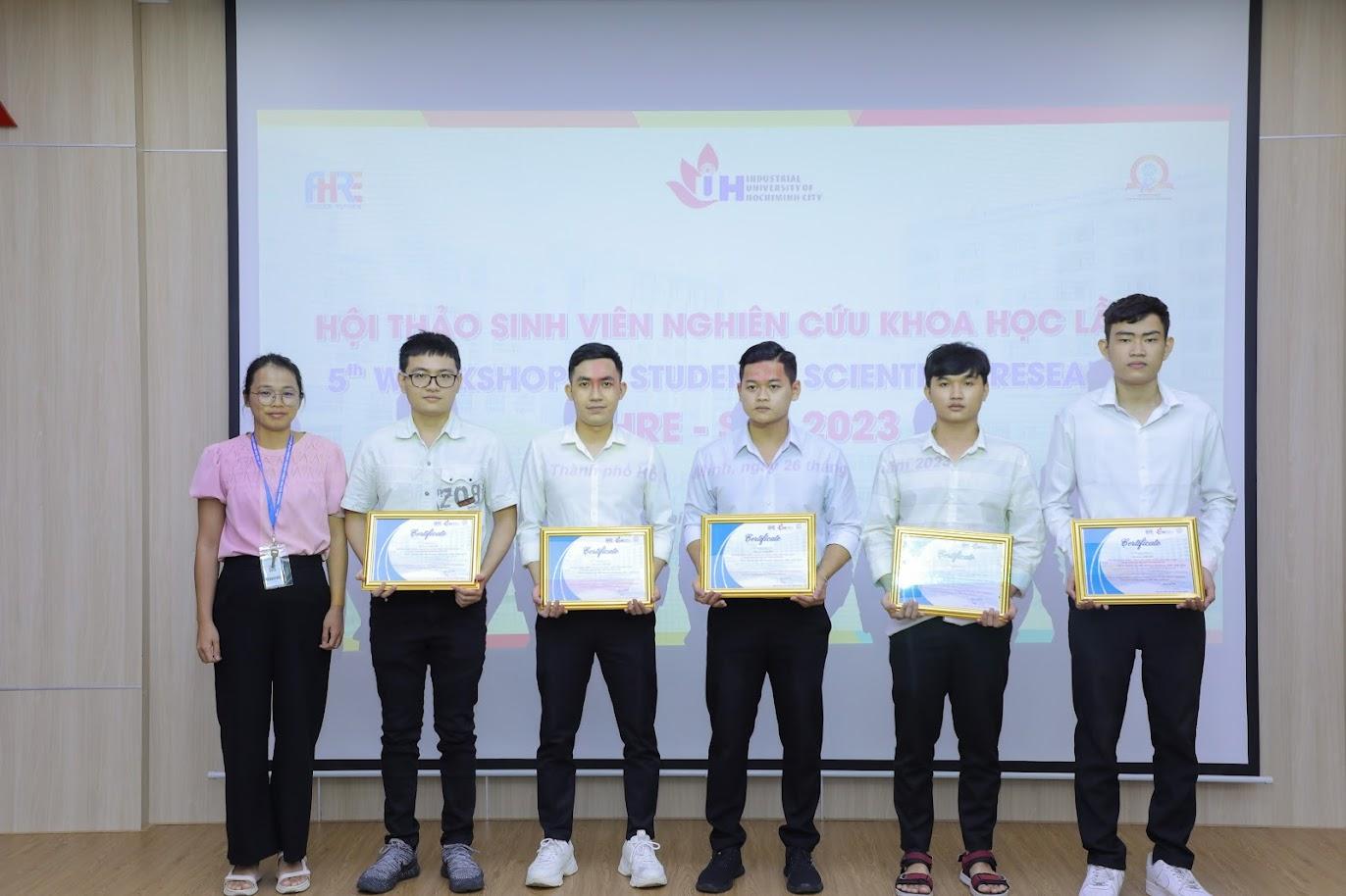 A group of people holding certificatesDescription automatically generated