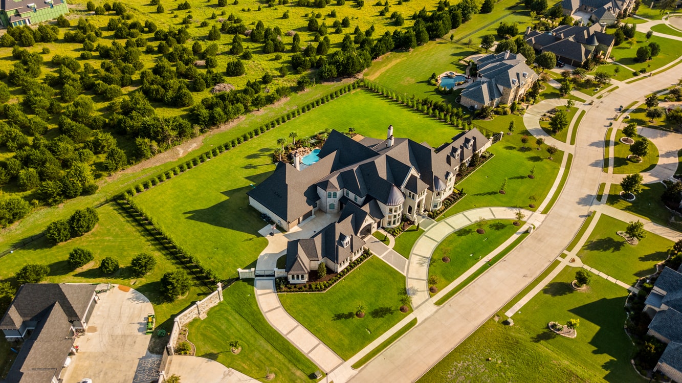 Aerial photo of mansions with a green yard | Luxury Real Estate: Why Venture in it?