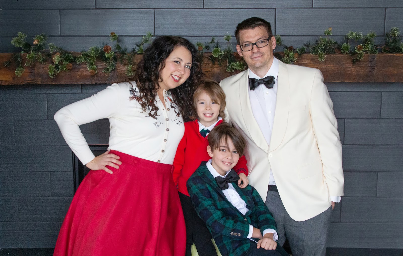 fun christmas card pose of family in formal christmas clothes for a holiday card