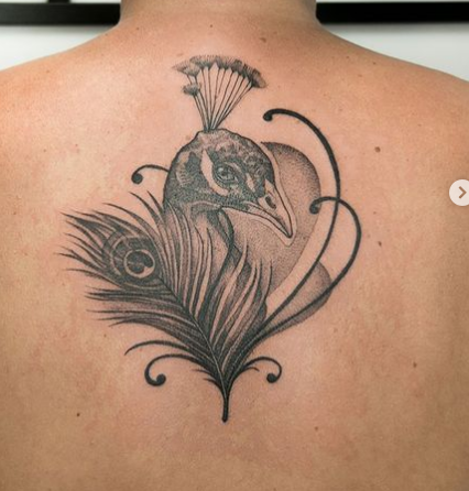 Outstanding Peacock Tattoo On Upper Back