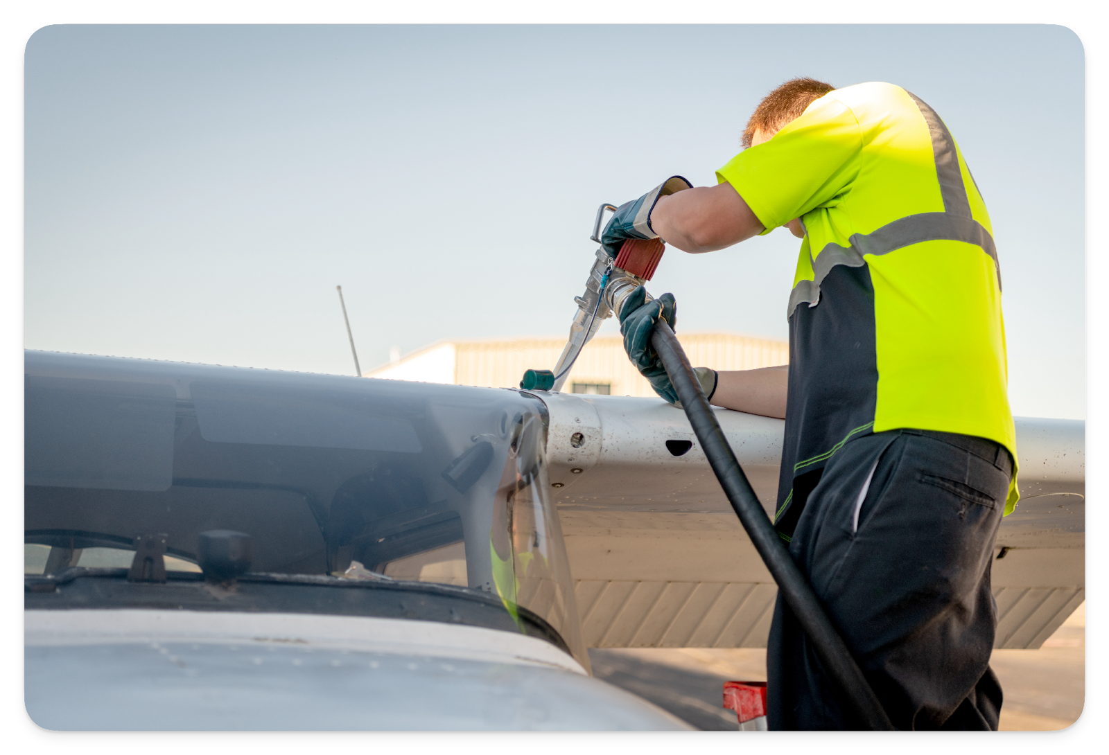 A pilot refueling their airplane.