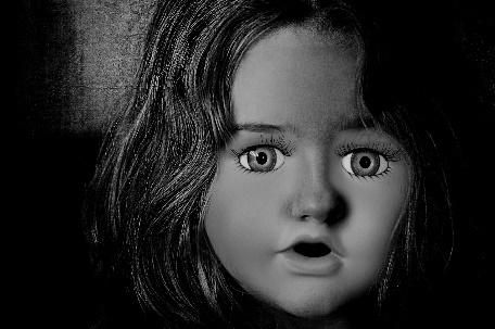 A close-up of a doll's face

Description automatically generated