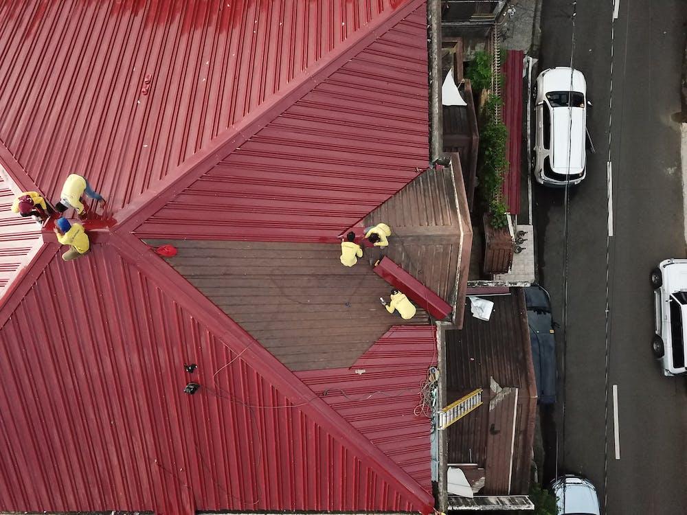 Free People Repairing House Roof Stock Photo