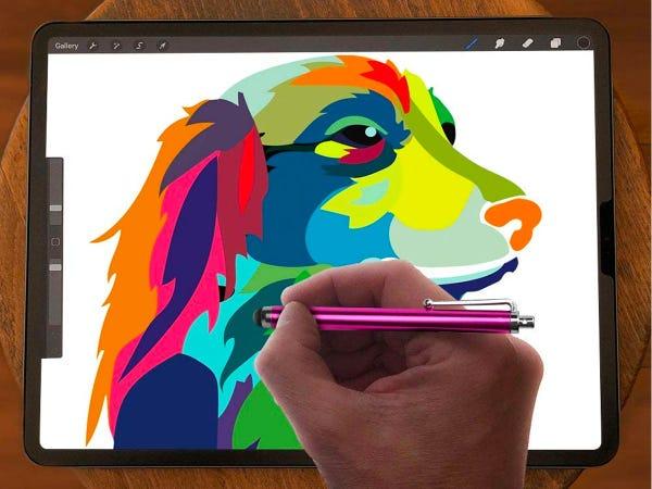 Hand holdig the Libberway Stylus Pen against iPad with colorful dog graphic on the screen