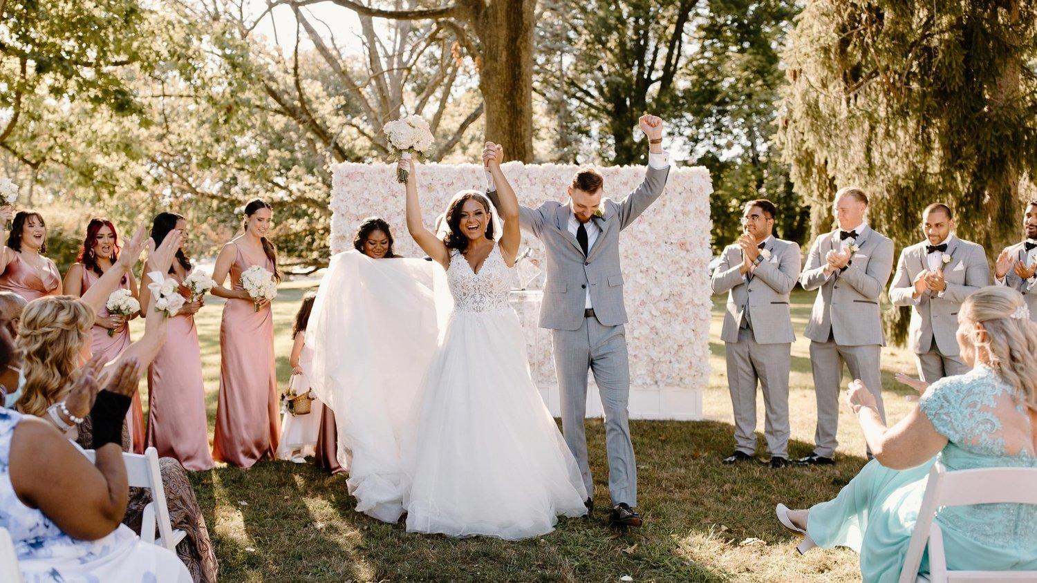 Couple smiling as they exit their wedding ceremony