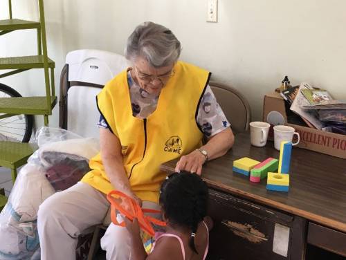 volunteers play with children