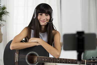 Music Therapy: Girl attending online guitar class.
