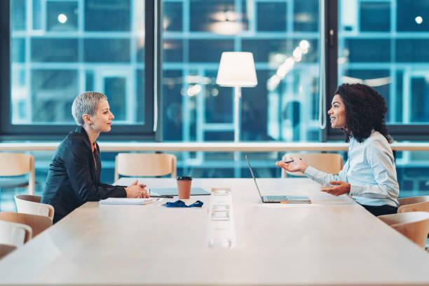 Building the business together Two businesswomen sitting face to face in the office and talking business consultant stock pictures, royalty-free photos & images