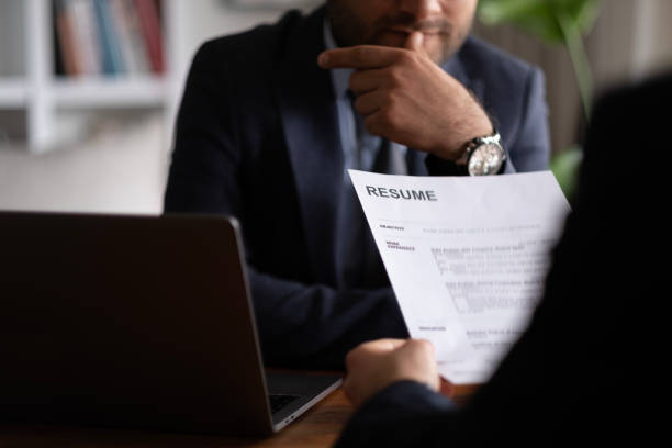 a man looking at business analyst resume
