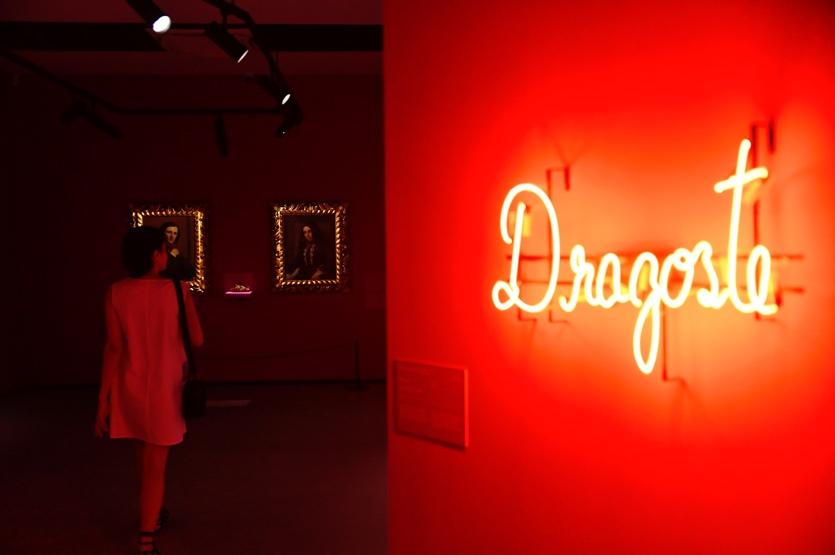 A person taking a picture of a red sign  Description automatically generated