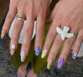 A close-up of a person's hands with painted nails

Description automatically generated