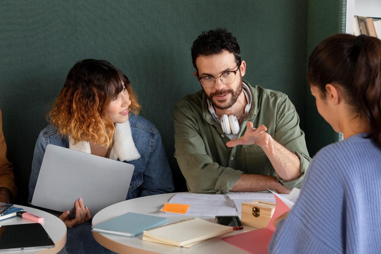 A group of people sitting around a table

Description automatically generated