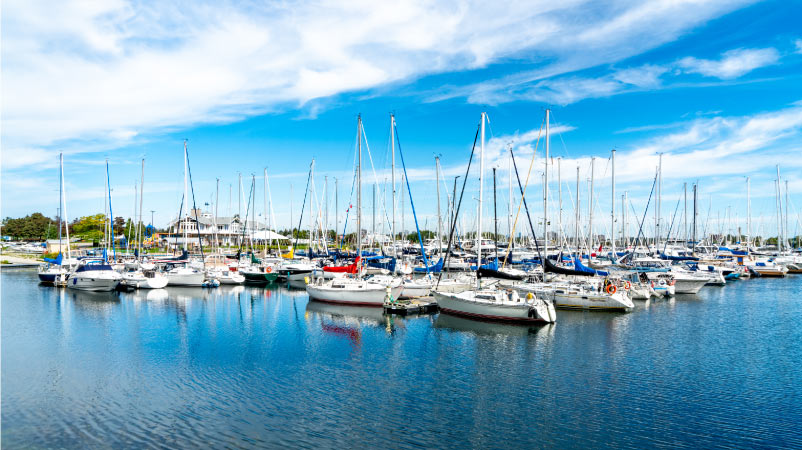 Dozens of sailboats are docked at Lakefront Promenade Marina on a sunny day in Mississauga, Ontario, Canada.
