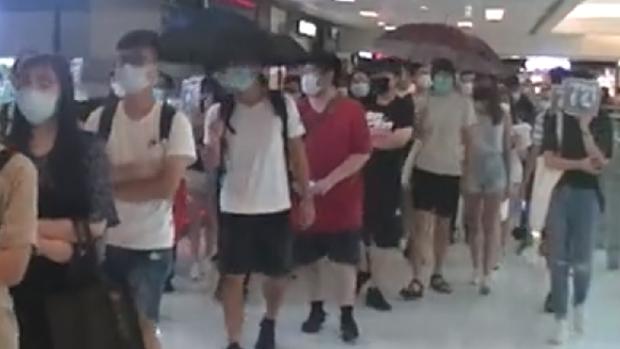2019年7月20日,示威人士在商场内游行,有店铺拉闸。(网上视频截图)