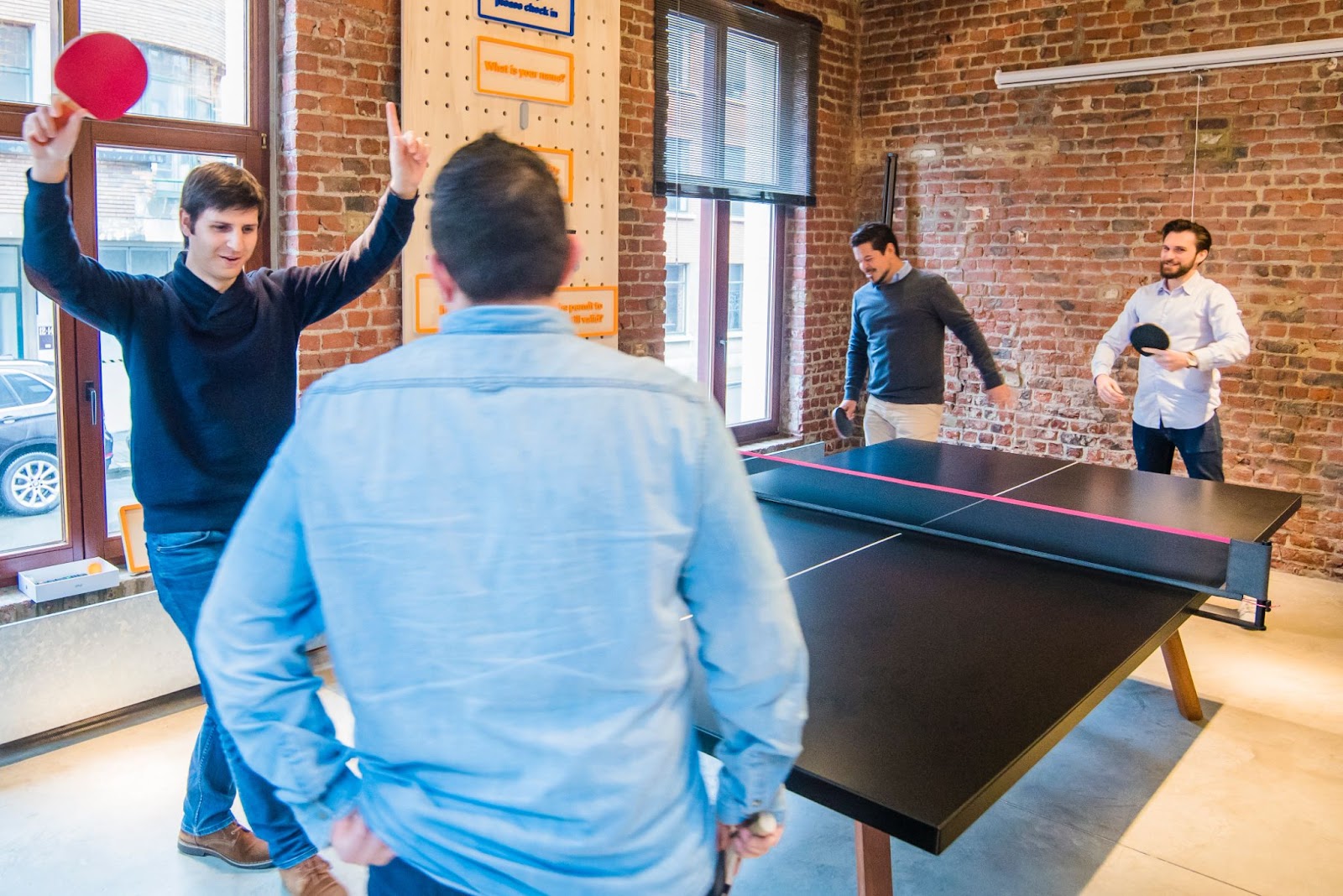 pessoas jogando ping pong enquanto aprendem inglês brincando