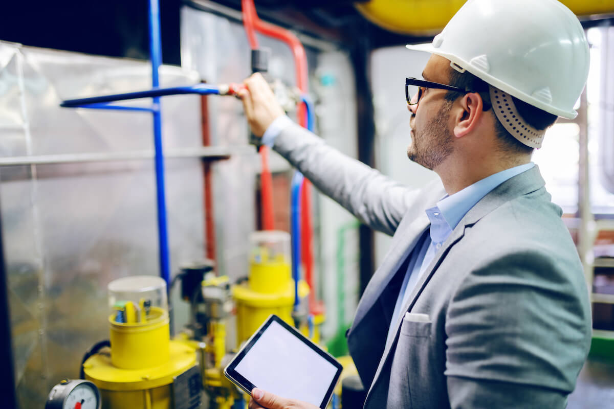 Person wearing a hard hat while conducting inspections