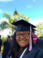 A person wearing a graduation cap and gownDescription automatically generated with medium confidence