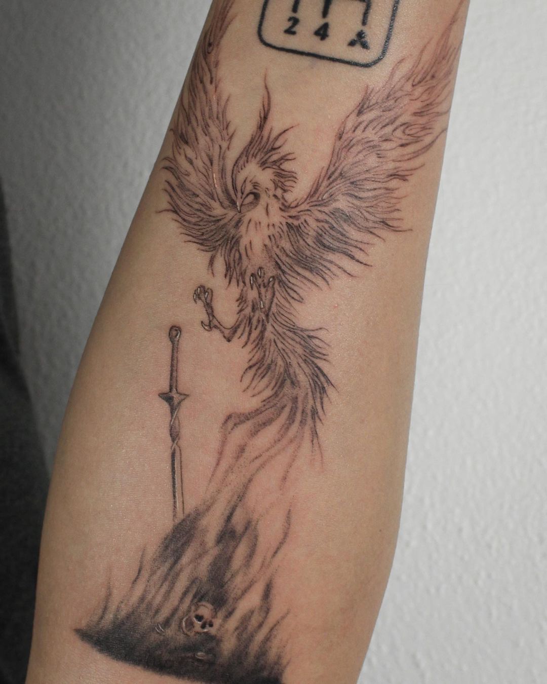 Phoenix With Sword And Skull Tattoo