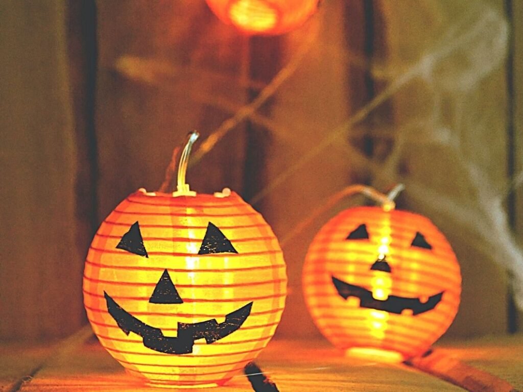 Blog post image with Halloween Jack-o-lanterns and store-bought spider webs placed on a home porch