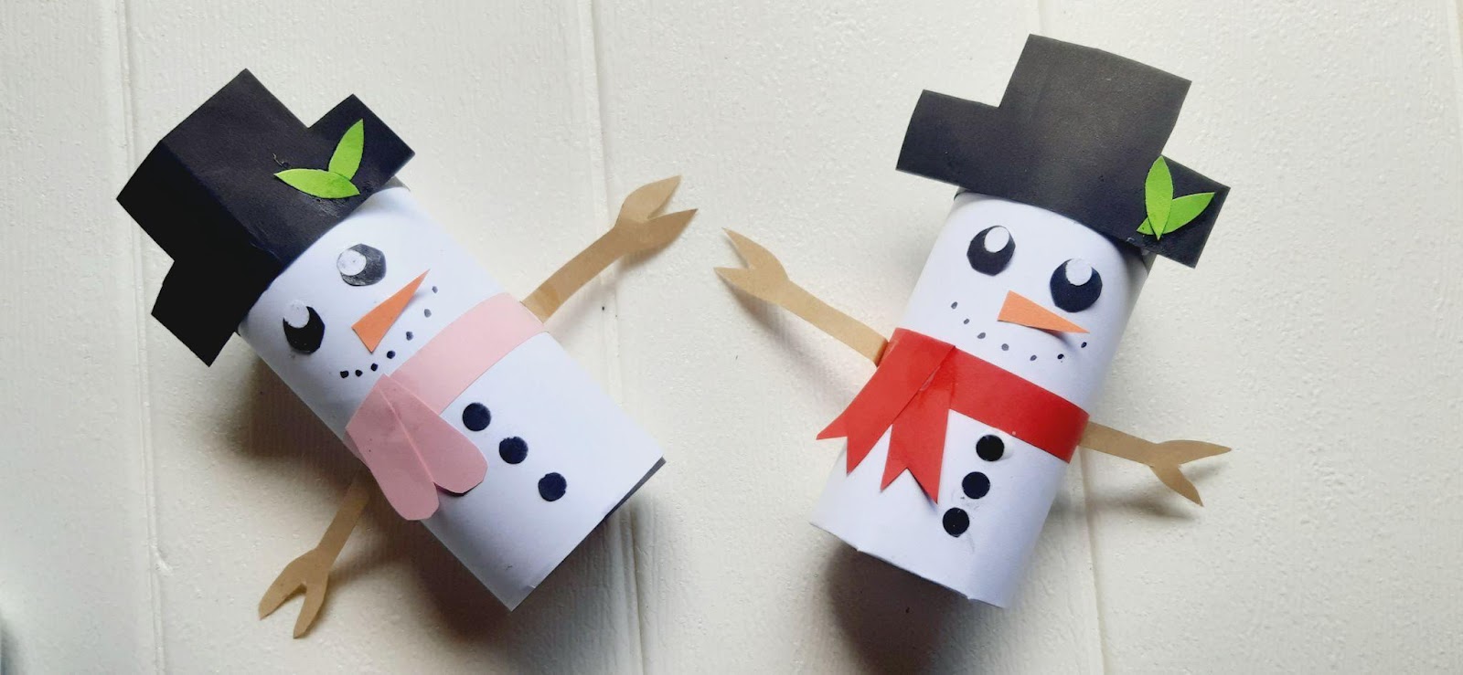 two toilet paper snowmen