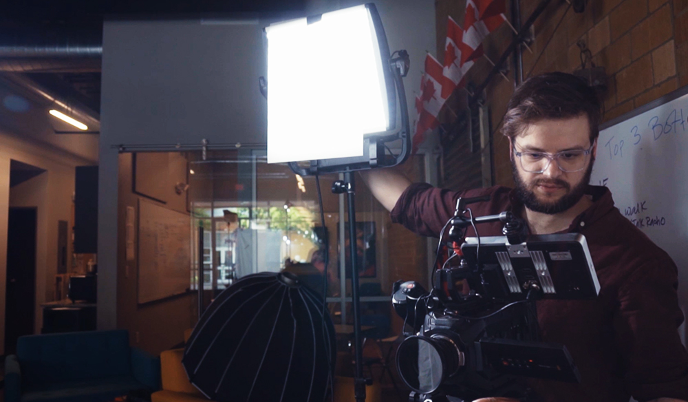 A man adjusting lightening for the interview