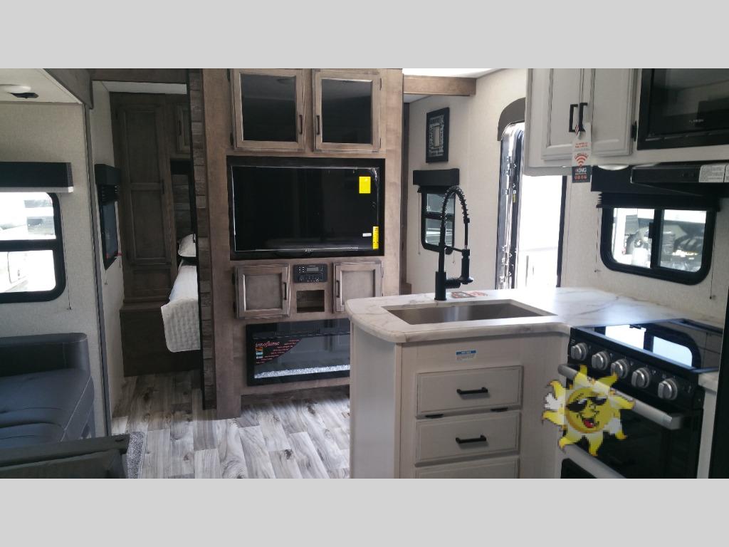 The entertainment unit in this RV features a fireplace underneath.