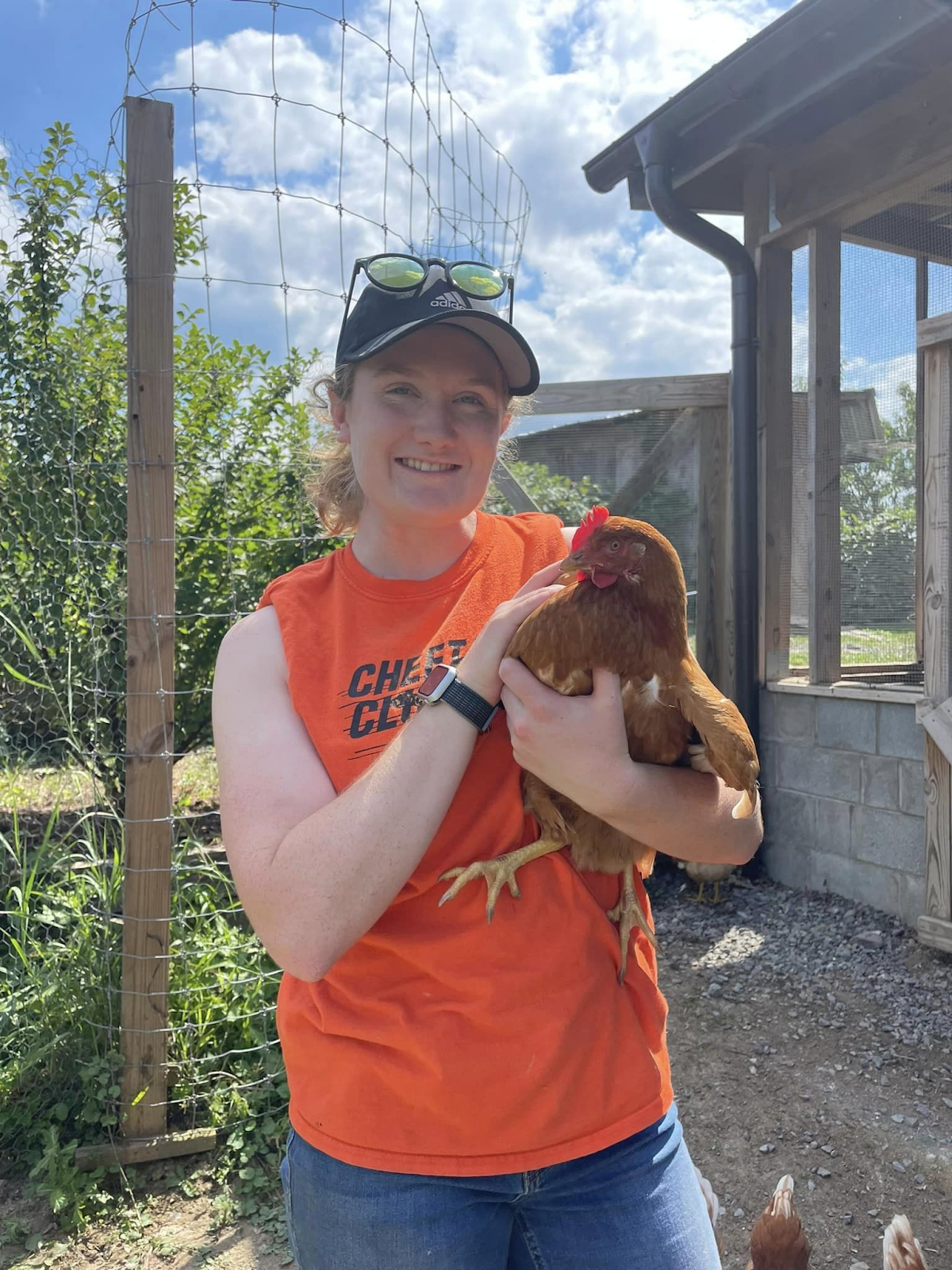 Morgan Pettlon holding a brown chicken