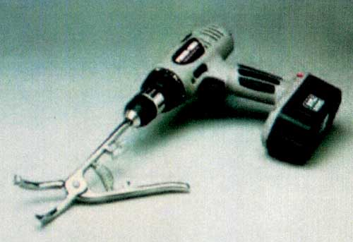 Henderson castrating instrument inserted into cordless 0.375-in drill. 