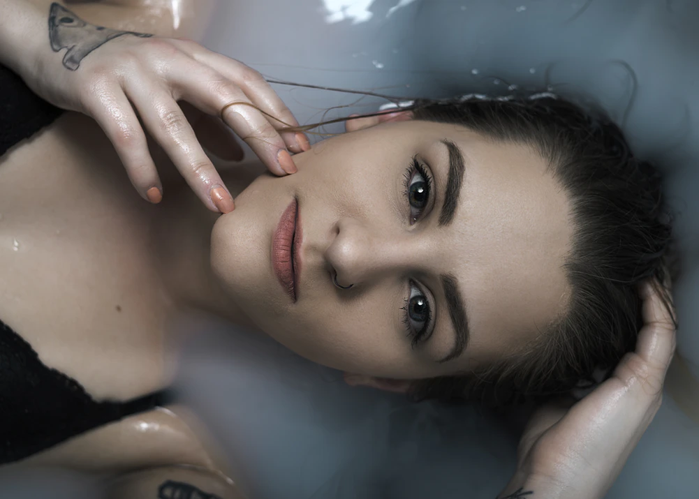 headshot of woman in milk bath 
