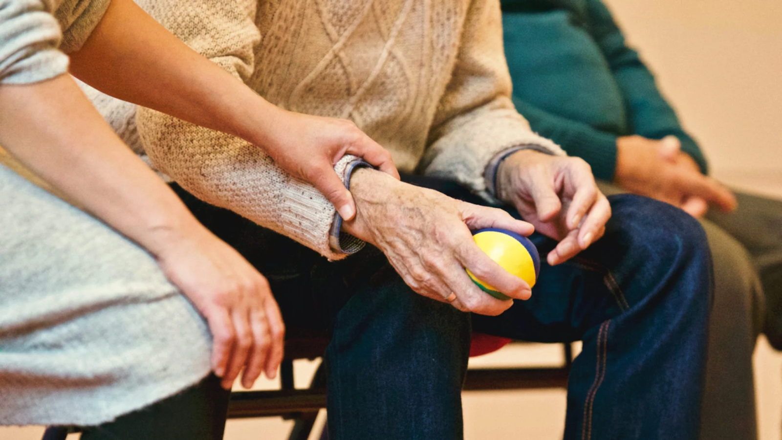 A senior patient squeezing a stress ball