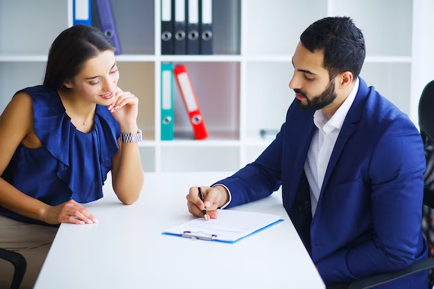 A financial advisor and a client signing a contract, showing how a well-designed finance firm influences a client's perception of professionalism.