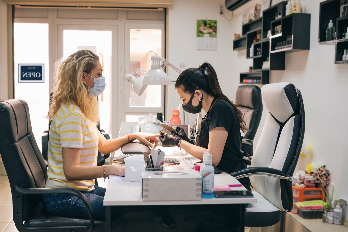 Image of salon worker doing nails. 