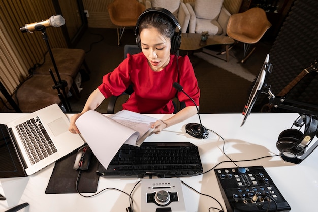 Free photo high angle woman working at radio with professional equipment