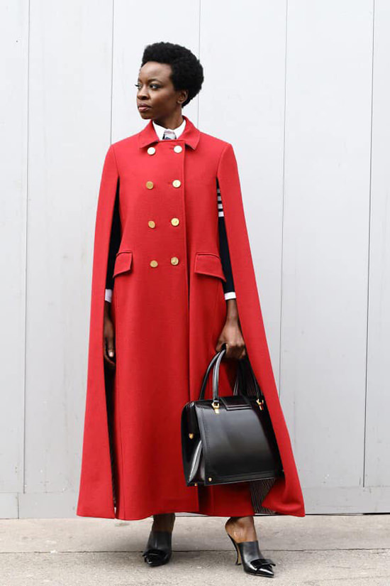 The stylish lady in red as depicted by Gurira