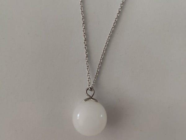 ball-shaped white pendant on silver chain