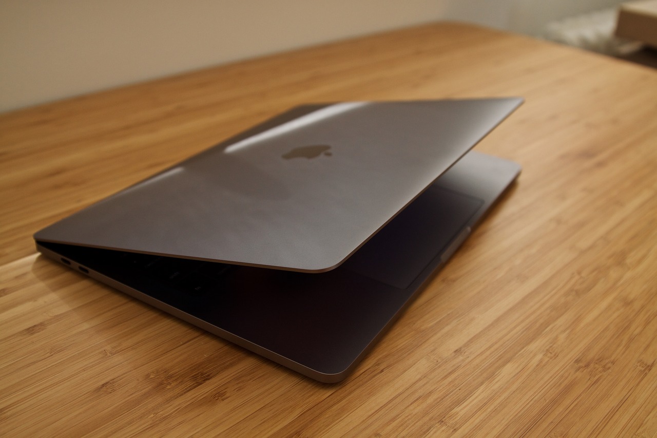 This image shows the Apple MacBook Pro 2022 in the tilt shape in the table.