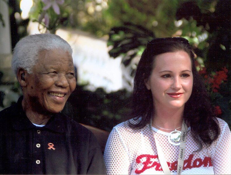 Nelson Mandela seated with a female