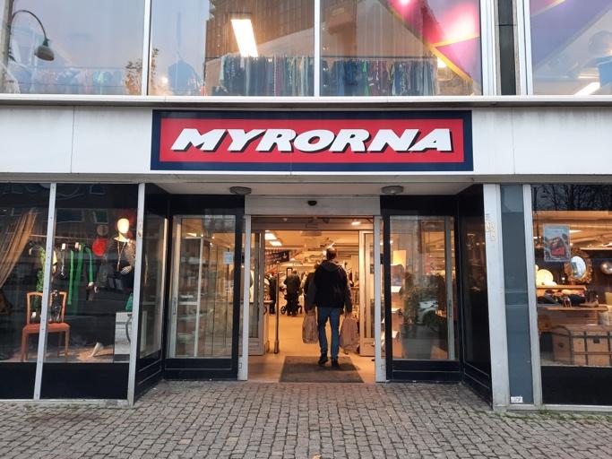 A person walking out of a store

Description automatically generated with medium confidence