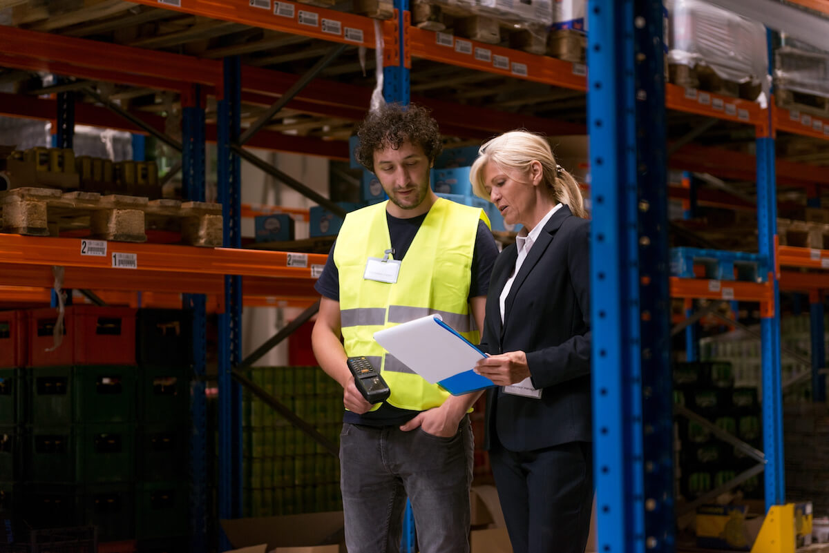 Supervisor talking to a warehouse personnel