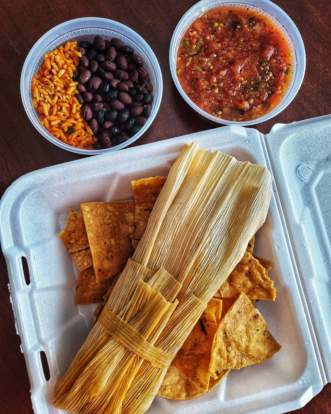 Hot and spicy pork tamale, rice, black beans, and salsa from The Tamale Place