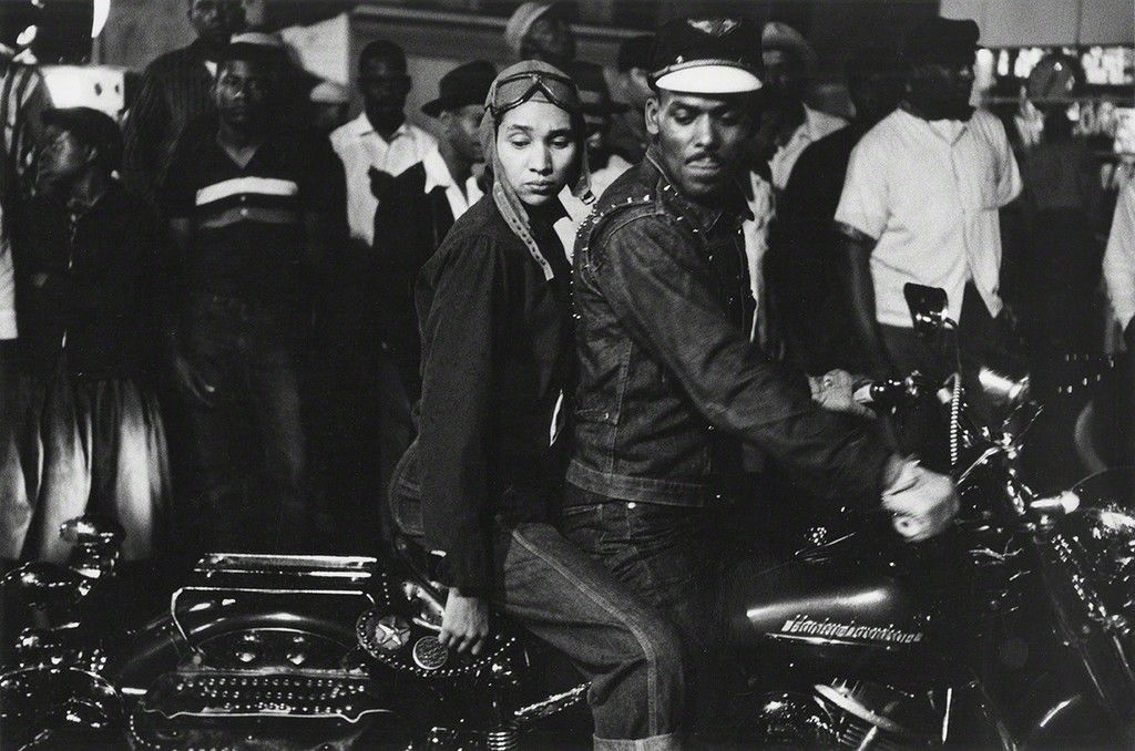 A black and white image of  a couple on a motorbike by famous photographer Robert Frank